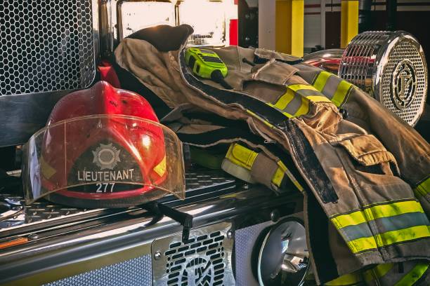 istock Firefighter helmet and gear on the fire truck 1164354078