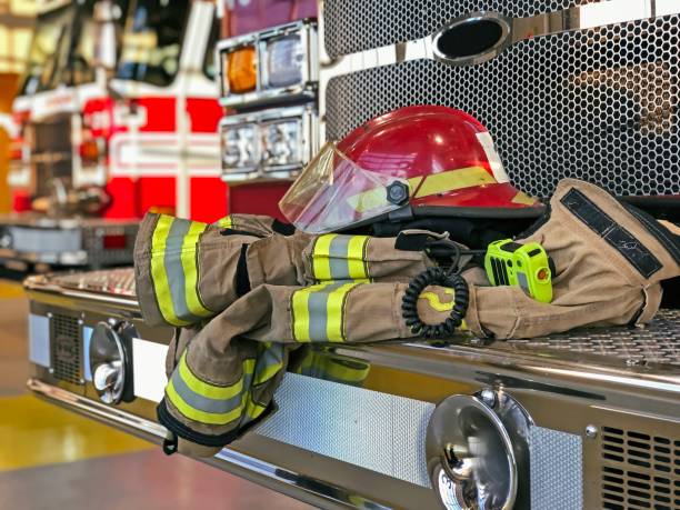 istock Firefighter helmet and gear on the fire truck 1164354079