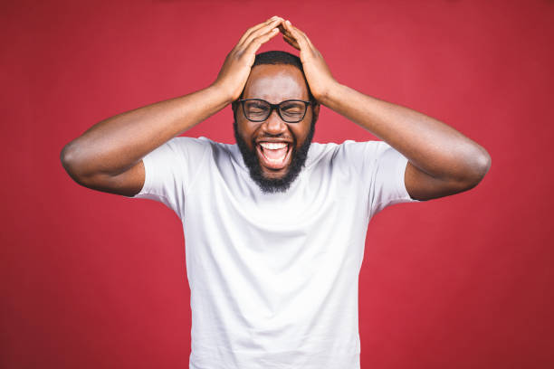 istock Upset unhappy dark-skinned male student squeezing head with hands, writhing in pain, suffering from headache after he spent sleepless night preparing for exams. People, stress, tension and migraine 1164355401
