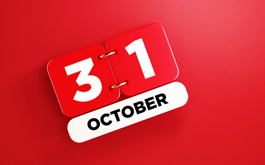 Red calendar on red background. October 31 writes on the calendar. Horizontal composition with copy space. Top view. Halloween.