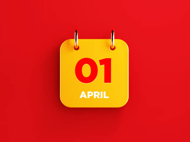 Yellow calendar on red background. April 1 writes on the calendar. Horizontal composition with copy space. Top view.