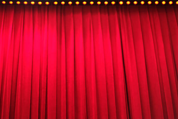 deep red closed curtain look up at deep red closed curtain under bright yellow stage light curtain call stock pictures, royalty-free photos & images