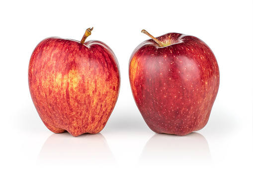 Group of two whole fresh apple red delicious isolated on white background
