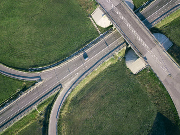 istock Road Junction highway intersection summer morning with car. Aerial Top View 1164365000