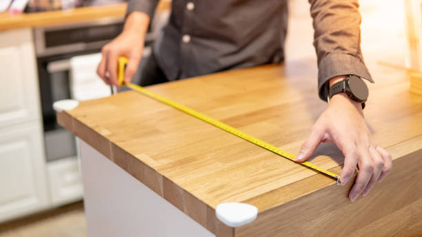 istock Male hand using tape measure on countertop 1164367149