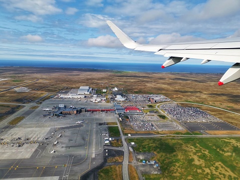 View from commercial airplane through window on top of Reykjavik Airport during day time