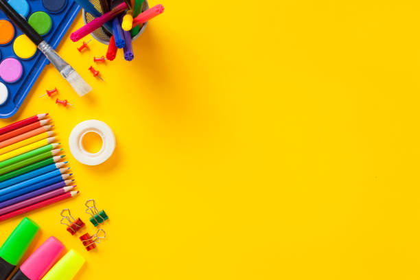 istock School supplies on yellow background. Back to school concept. 1164369209