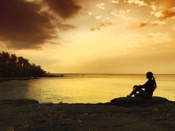 istock Woman at sunset 1164369239