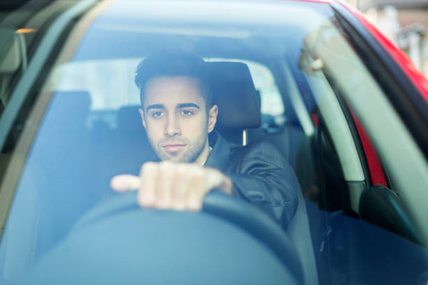 istock Businessman driving a car 1164370104