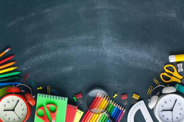 istock School supplies on blackboard. Back to school concept. 1164370677