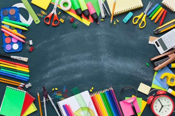 istock School supplies on blackboard. Back to school concept. 1164370754