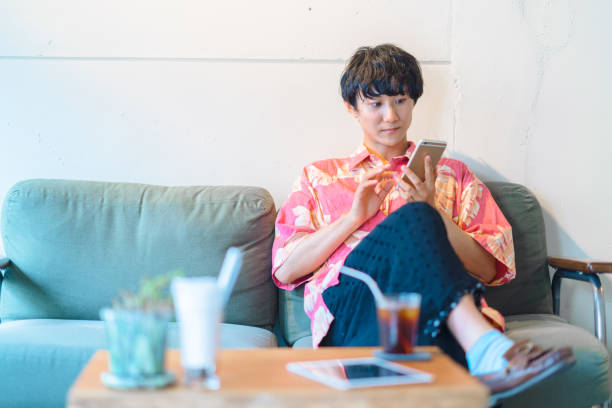 Modern man doing e-banking in cafe A millennial modern man is doing electronic bookkeeping on a laptop in a cafe. He is doing e-banking in a cafe. japan restaurant bill stock pictures, royalty-free photos & images