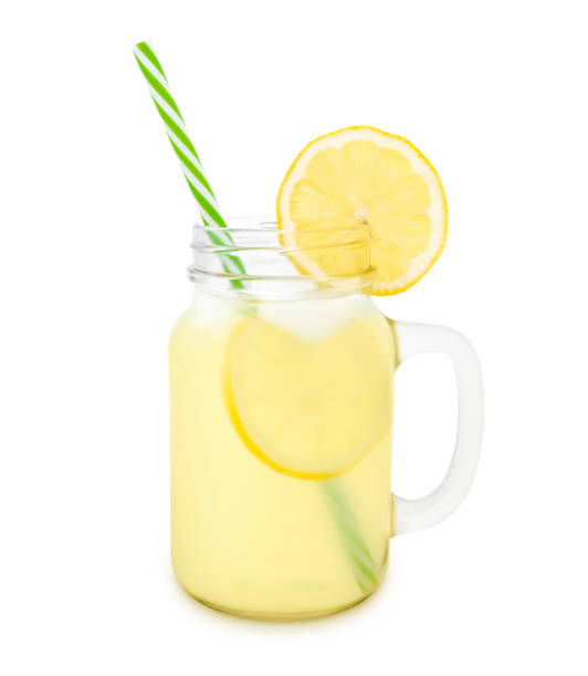 Lemonade in a Jar Lemonade in a jar with lemon slice isolated on white lemonade stock pictures, royalty-free photos & images