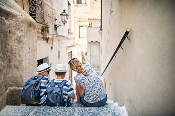 Mother and sons sightseeing narrow backstreets of Amalfi, Italy Mother and sons sightseeing Italian town of Amalfi in Campania. Family is sitting on steps in a pictoresque and atmoshperic backstreet. Boys are holding a map and mother is explaining the directions.
Nikon D850 amalfi coast map stock pictures, royalty-free photos & images
