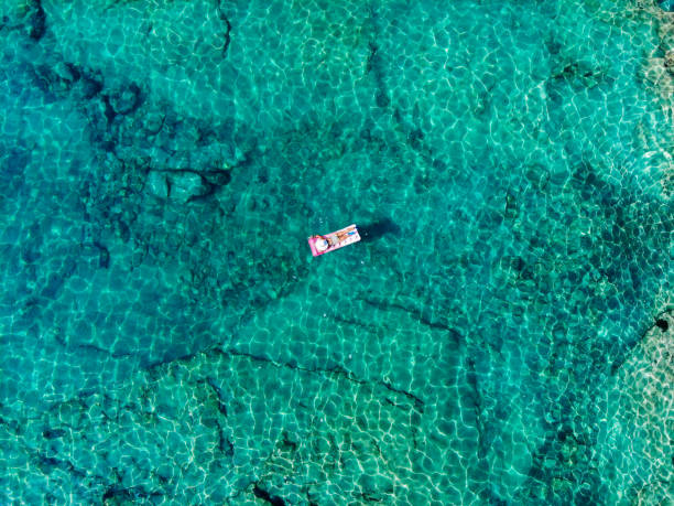istock Drone image of woman on seabed. 1164374985