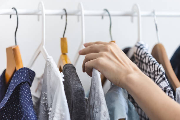 istock Female hand chooses clothes on a hanger 1164375087