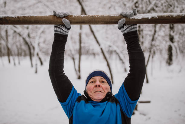 istock Senior man jogging in snow 1164376013