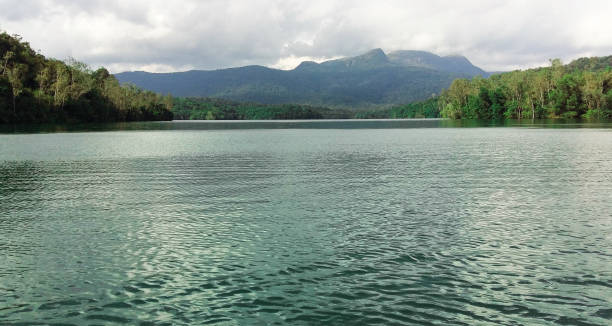 lago con montagne sullo sfondo. - flowing river water dam foto e immagini stock