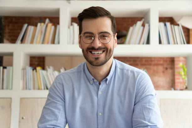 istock Happy businessman coach teacher webinar speaker looking at camera 1164377499