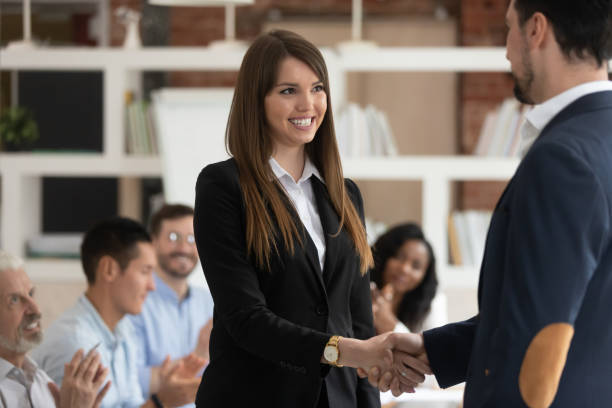 istock Happy female worker get rewarded for good work handshake boss 1164377503