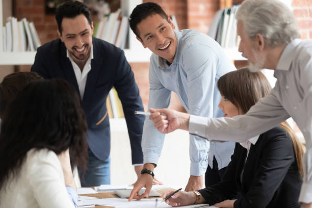 istock Happy diverse business team talking gather at conference table 1164377507