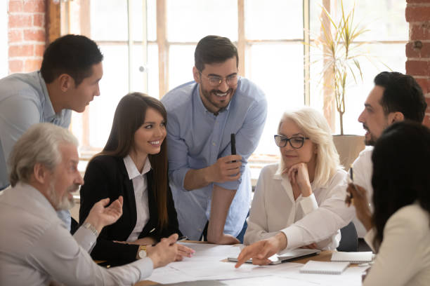 istock Happy diverse business team talking brainstorming gathered at table 1164377509