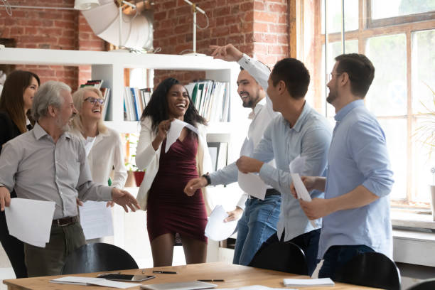 istock Excited business team people dancing holding papers celebrate successful contract 1164377557