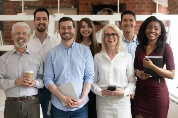 istock Happy diverse business team standing in office looking at camera 1164377664