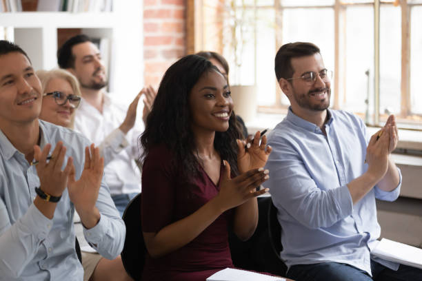 istock Multiracial happy business audience people applaud thank for workshop presentation 1164377665