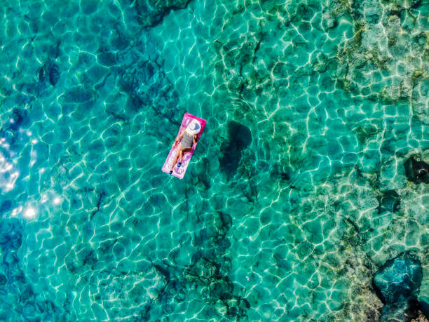 istock Drone image of woman on seabed. 1164379353