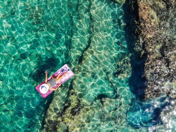 created by dji cameraDrone image of woman on seabed.