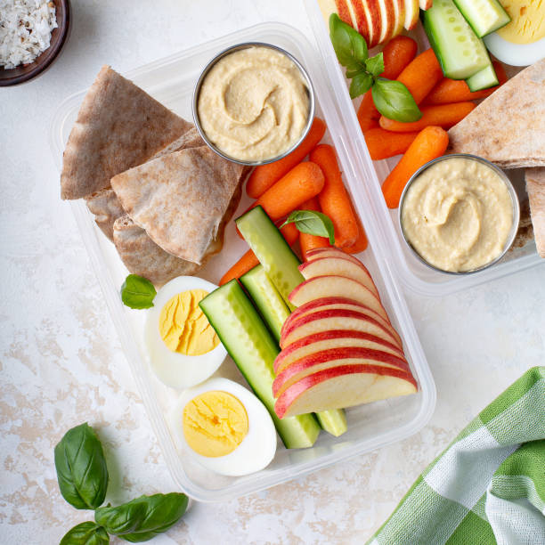 Healthy and nutricious lunch or snack boxes Healthy and nutricious lunch or snack boxes to go with hummus and pita, eggs and vegetables pita bread stock pictures, royalty-free photos & images