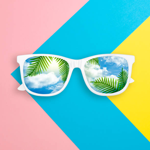 istock Summer concept. Creative layout made of white sunglasses with reflection sky and cloud on multicolored paper background.  Sunglasses mockup as design element vacation and travel top view 1164380988