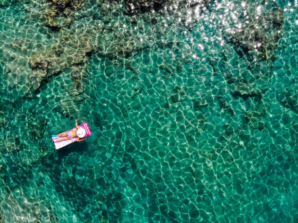 istock Drone image of woman on seabed. 1164381624
