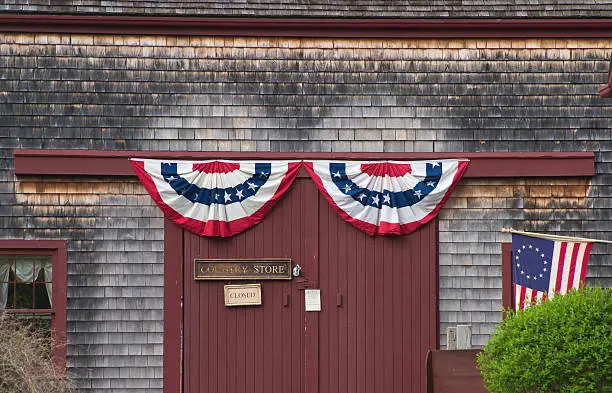 Flags hang outside rural country store.