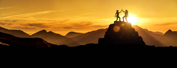 istock Two women high five on a mountaintop 1164383033