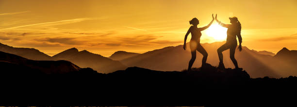istock Two women high five on a mountaintop 1164383113