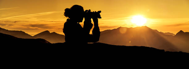 istock Photographer at sunrise in the mountains 1164383114