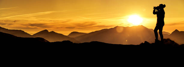 istock Photographer at sunrise in the mountains 1164383116