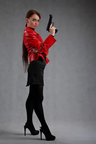 Photo of Full-length portrait of a woman with a gun