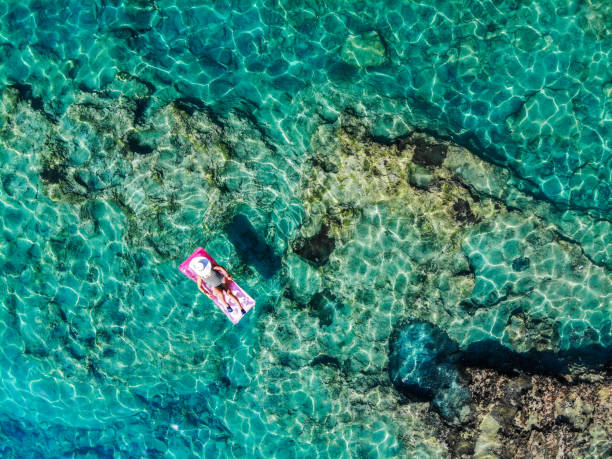 istock Drone image of woman on seabed. 1164383627