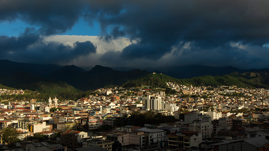 Panoramic view of the city of Loja in Ecuador with mountains on the horizon on a cloudy afternoon before the storm