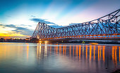Howrah bridge on river Ganges at Kolkata at twilight with moody sky