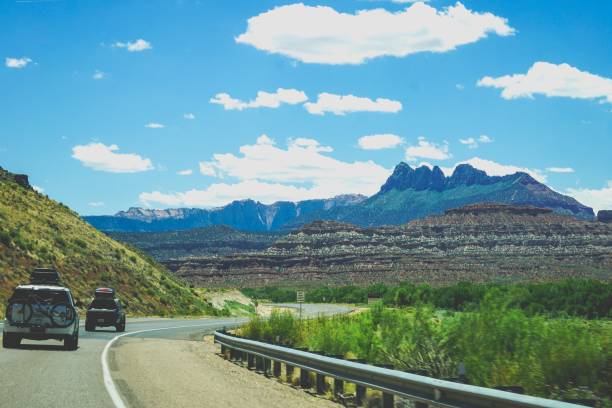 istock cars driving on winding road with mountains 1164386472
