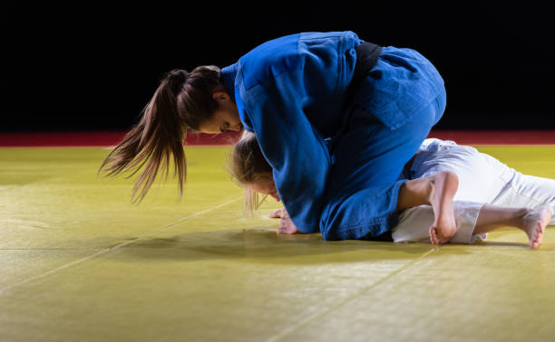 istock Two Female Judo Practitioners Grappling On A Tatami Mat 1164387329