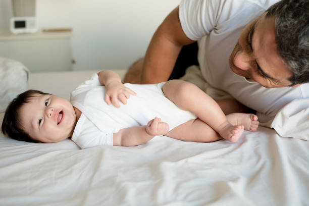 istock Happy baby and dad in bed 1164387683