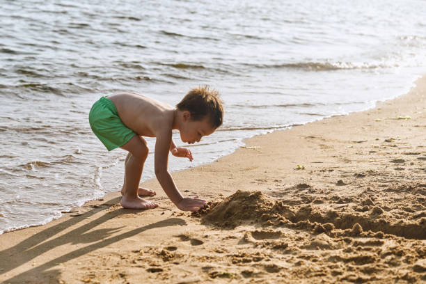 istock Cute child having fun on the beach 1164387994