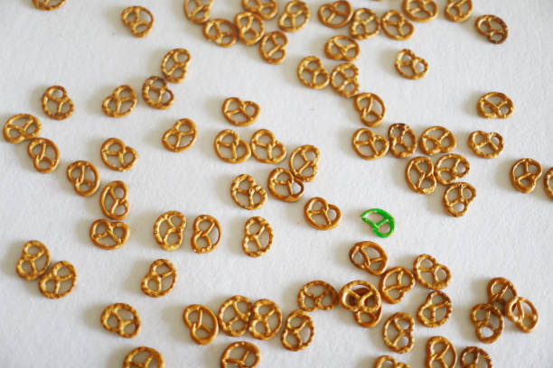 Pretzels on white background, one of them is different from the others.