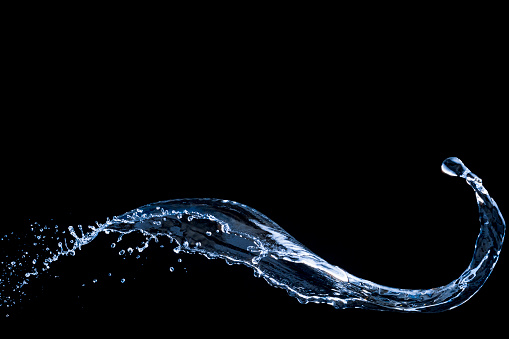 water splash photographed with high speed flash on black background