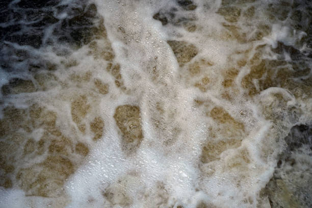 istock Fast flowing water over a small weir 1164390606